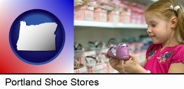 little girl holding a shoe in a shoe store in Portland, OR